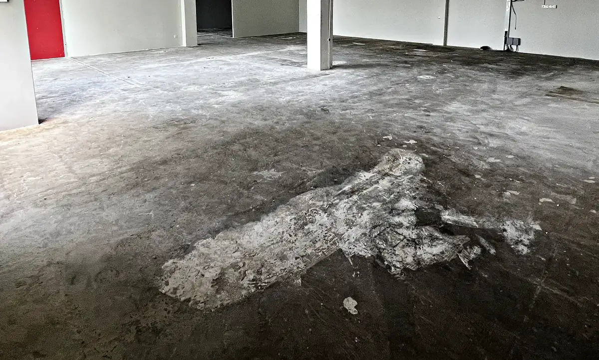 Patch in a concrete slab where a partition was removed, one on site sign of an unapproved alteration