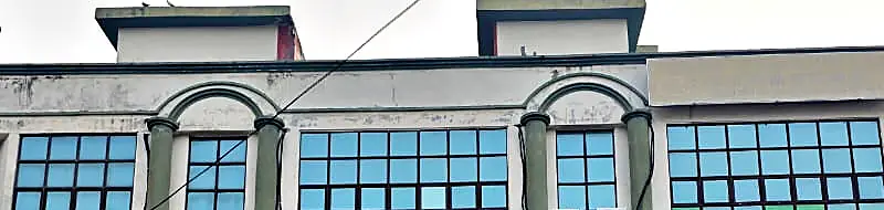 Structures above the parapet line of a Malaysian shop lot, the kind of roof level addition that needs local authority approval