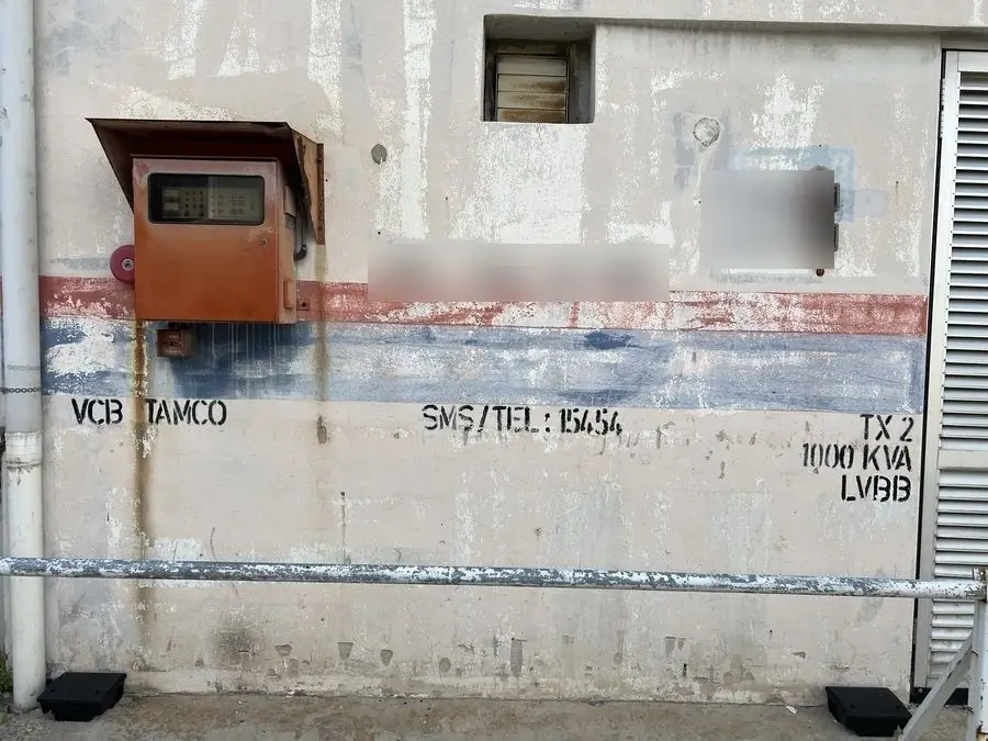 Substation wall stencilled TX 2, 1000 KVA, LVBB and VCB TAMCO, with the TNB fault reporting number below