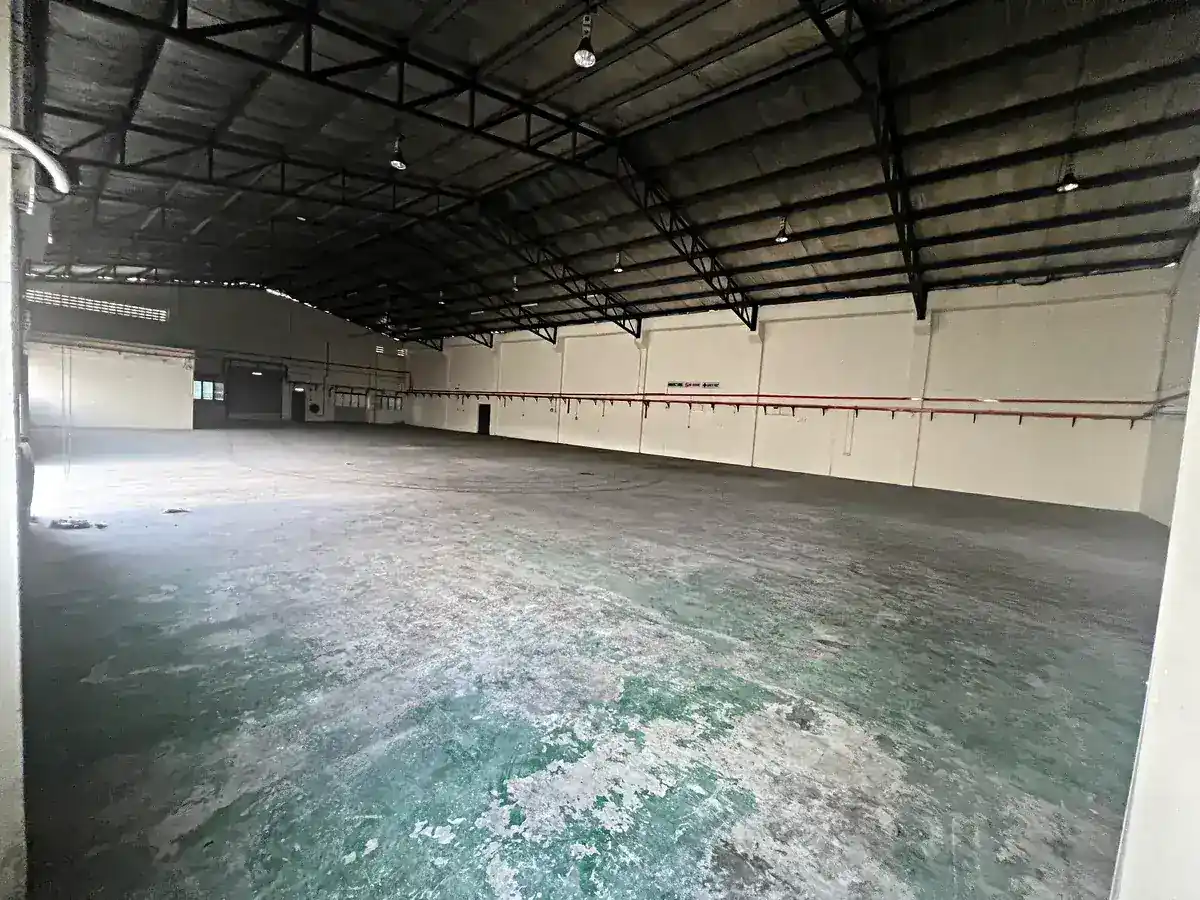 Empty industrial unit interior with bare walls and concrete floor, no fit-out in place